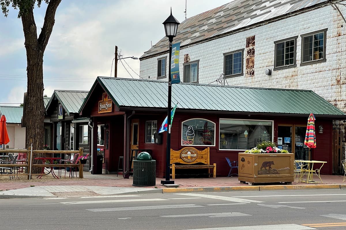 A storefront in Westcliffe, Colorado, called the Stage Shop on Main Street. The shop front is covered in patio chairs and benches.