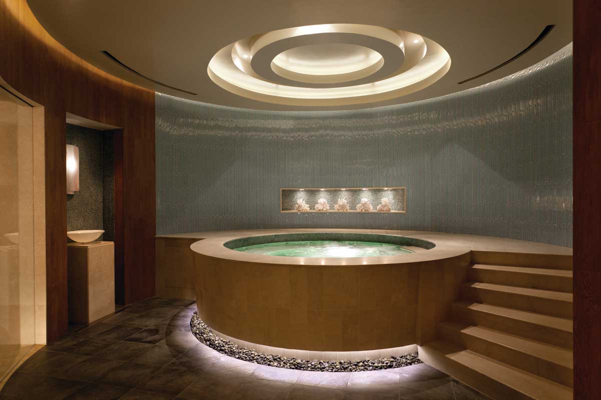 A spa tub in a dimly lit, circular room