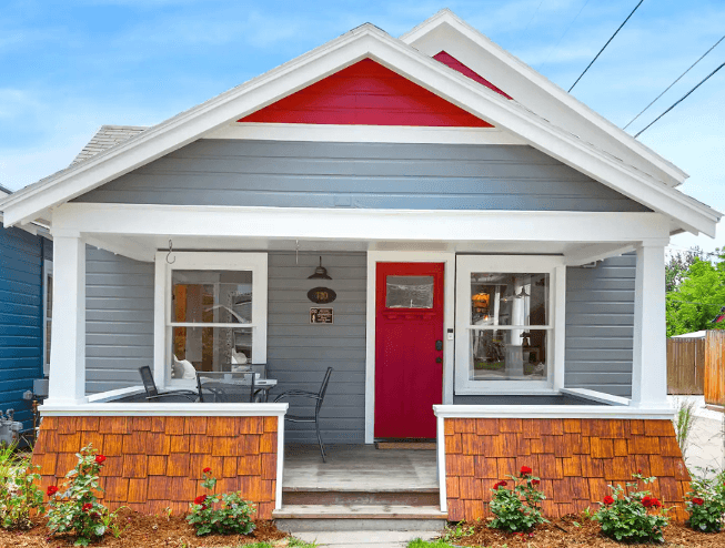 Exterior view of Aggie House in Louisville, Colorado, showcasing colorful pops of red on the house and a well-manicured lawn