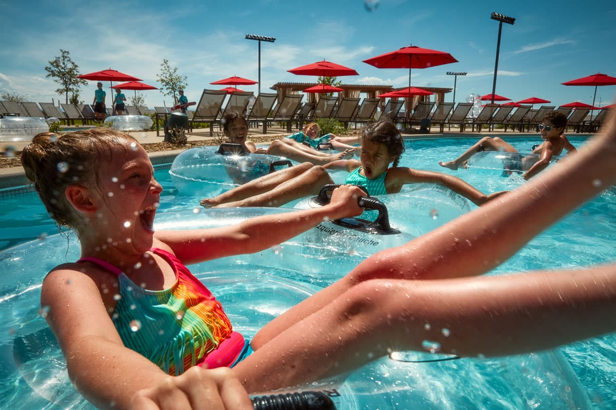 Children play joyously in the Gaylord Rockies Resort pool on a hot summer day.