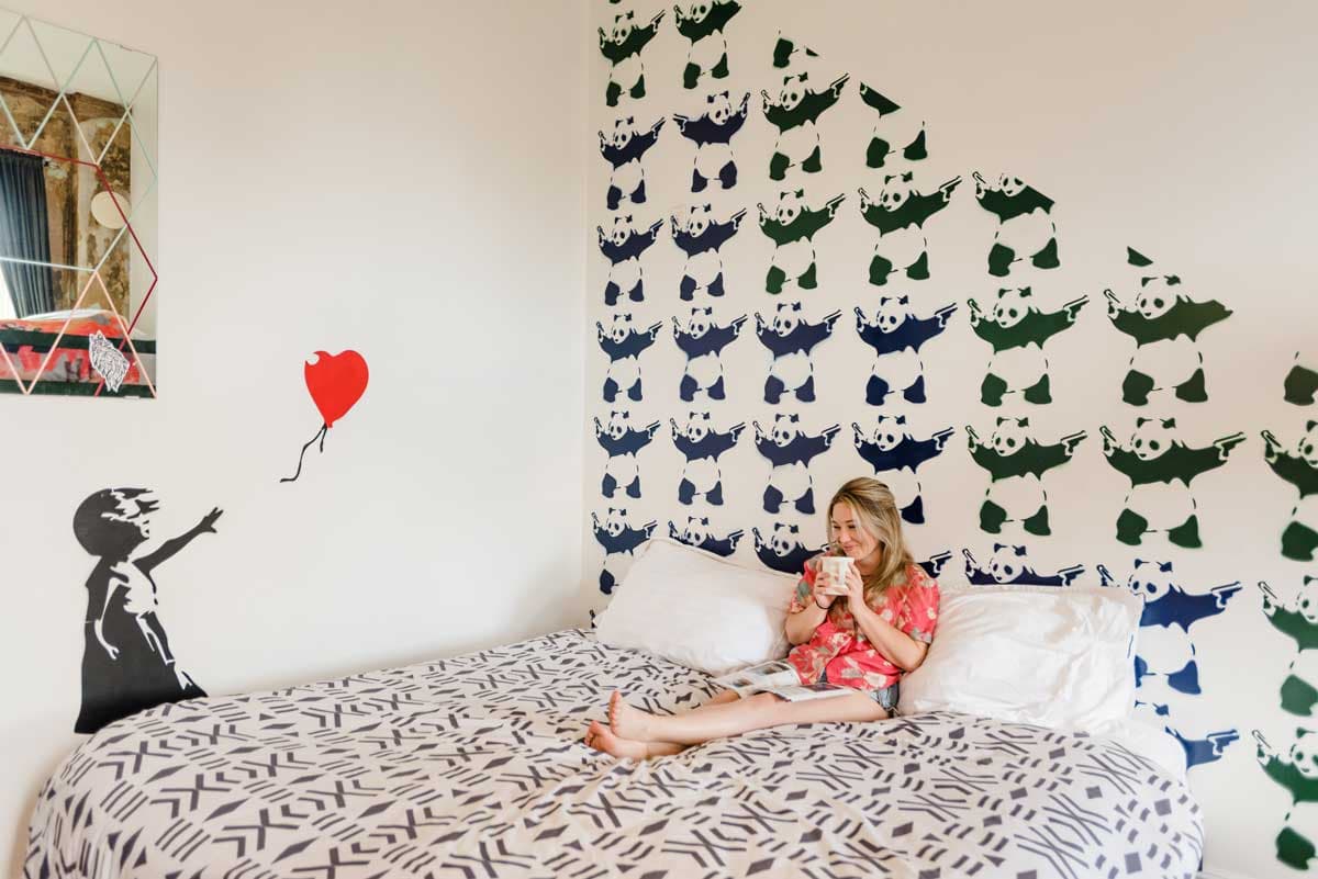 A single room at Hostel Fish in Denver is decorated with whimsical graffiti wall art