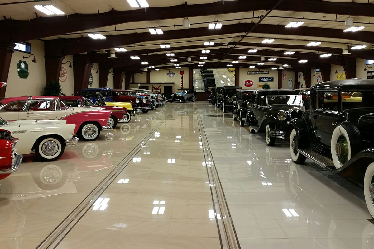 Vintage cars sit in lines on a shiny floor at the Rangely Automotive Museum.
