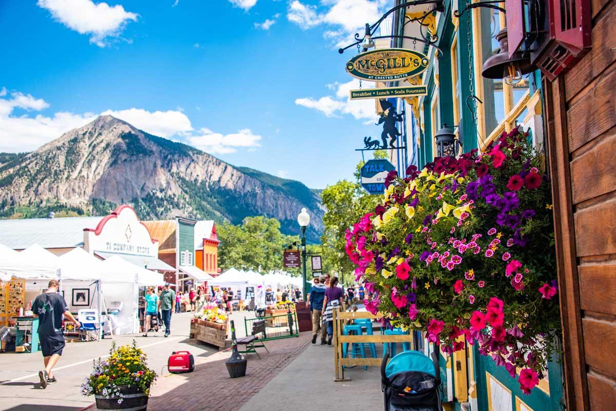 Colorful downtown Crested Butte surrounded by flowers and peaks