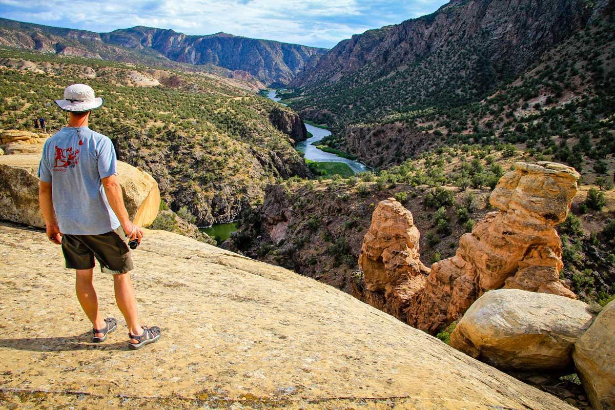 A man views the rock formations and river in Gunnison Gorge near Montrose