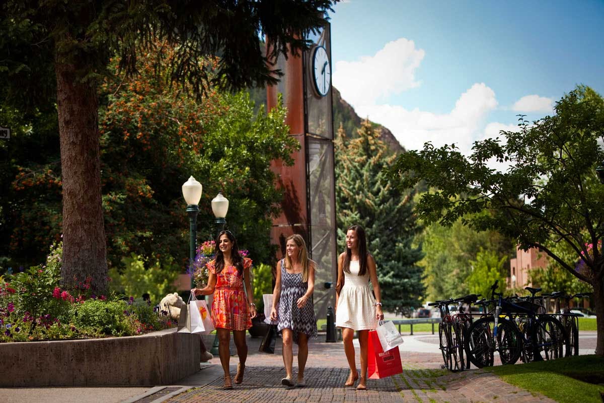 Three women walk through Aspen