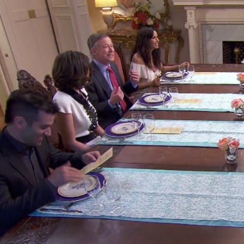 Top Chef judges at a dining table with plates in front of them