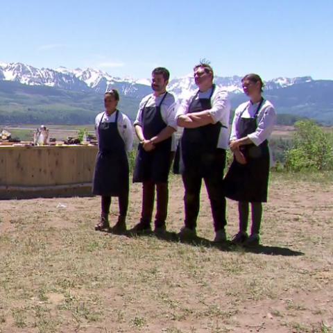 Colorado Top Chef finalists stand in black aprons with the San Juan mountains in the background