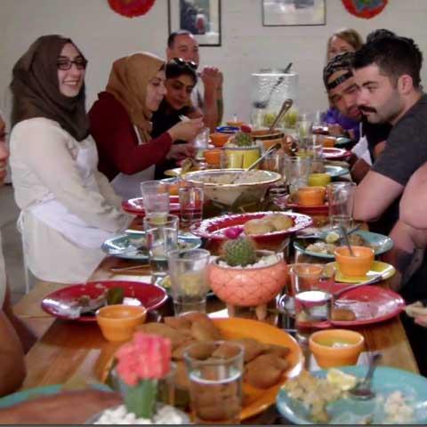 People dining at a packed and festive dinner table