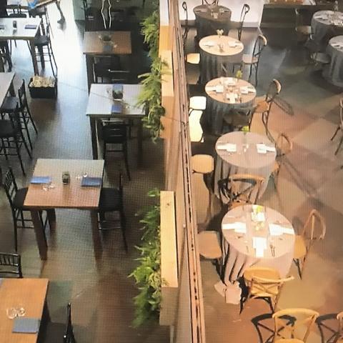 Rows of tables in a restaurant set for a meal