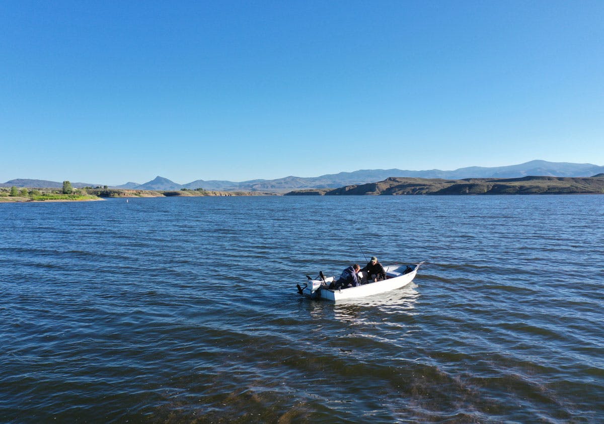 The blue waters of Kremmling's Wolford Mountain Reservoir undulate as a small fishing craft floats in search of the day's catch