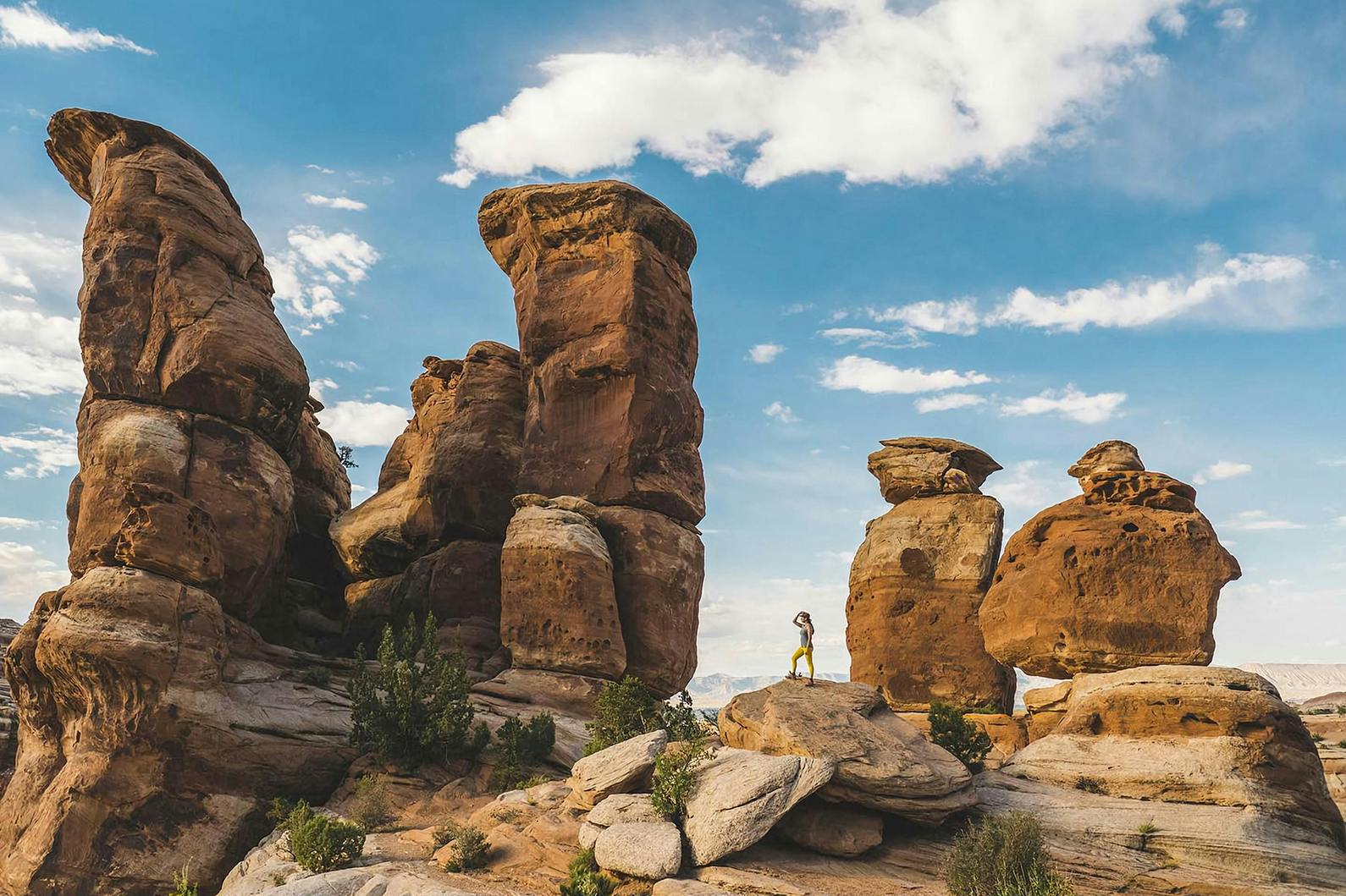 Hiker at Colorado National Monument Near Grand Junction stands atop red-rock spires