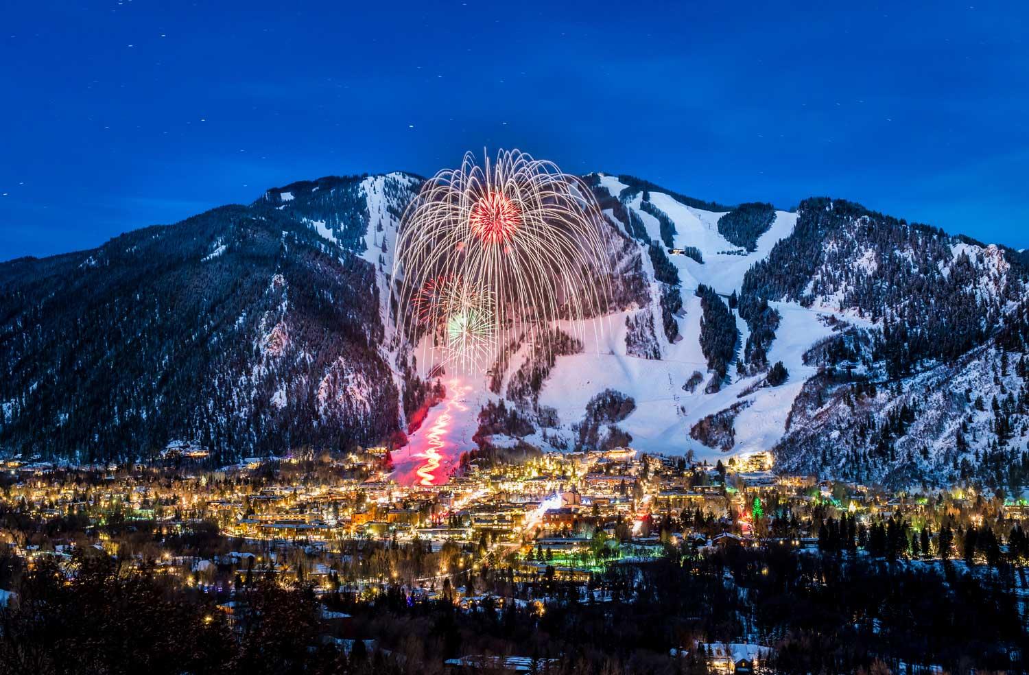 With a snow-covered mountain as it's backdrop, fireworks explode over Aspen's downtown.