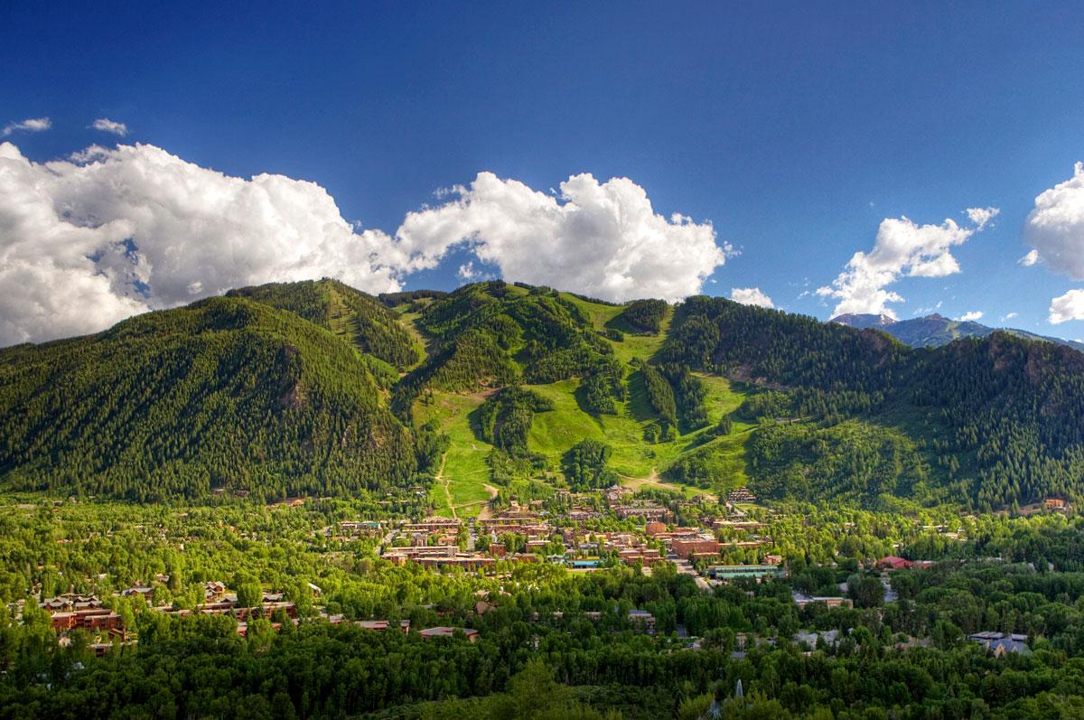 Aspen Mountain in Colorado is verdant and lush with thick forests covering its slopes and foothills and rich green meadows blanketing its winter ski trails.