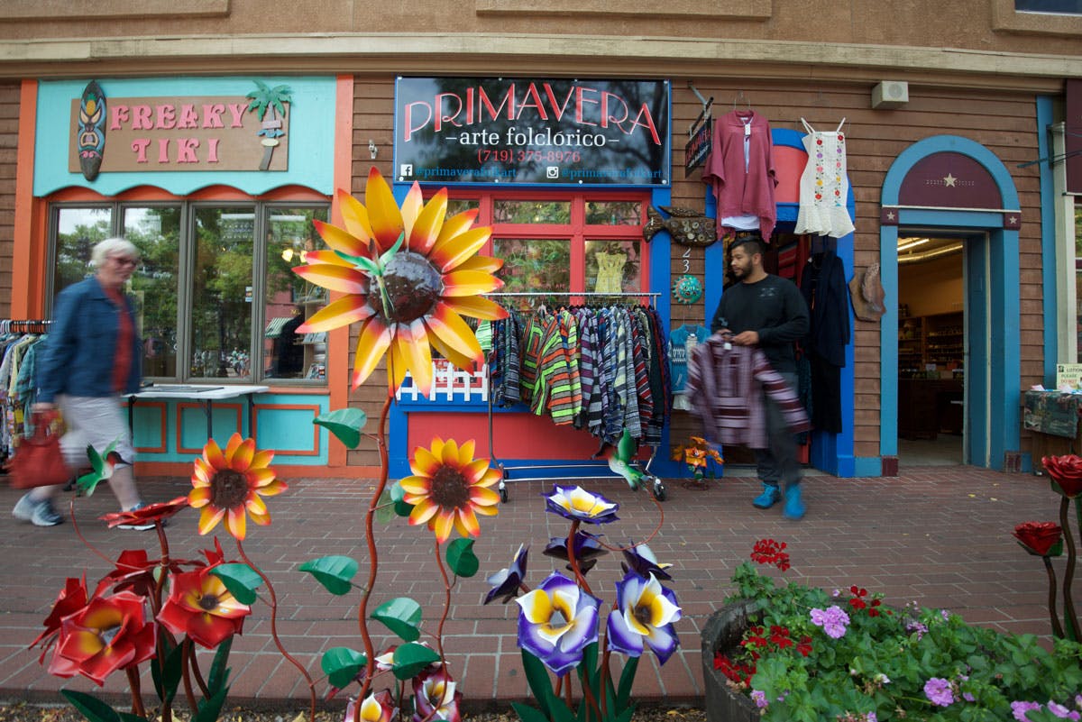 Bright yellow, red and purple metal flowers are on display in front of the boutiques in historic, old Colorado City. 