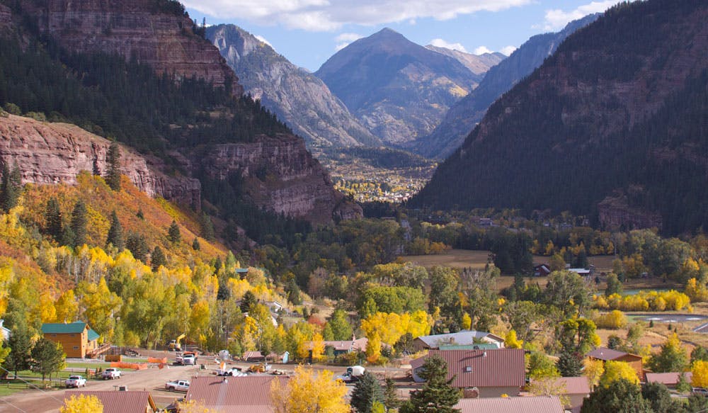 The small town of Ouray, Colorado, is nestled between a ring of purple peaks and yellow aspen trees