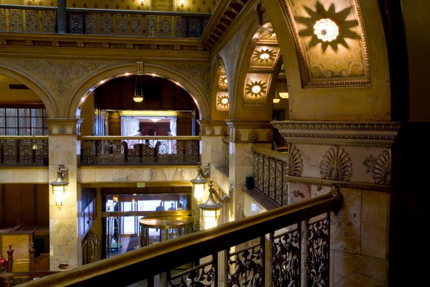 Accent lighting beneath arches and on tall white, stone columns illuminated the elegant interior of the Brown Palace Hotel in Denver, Colorado.