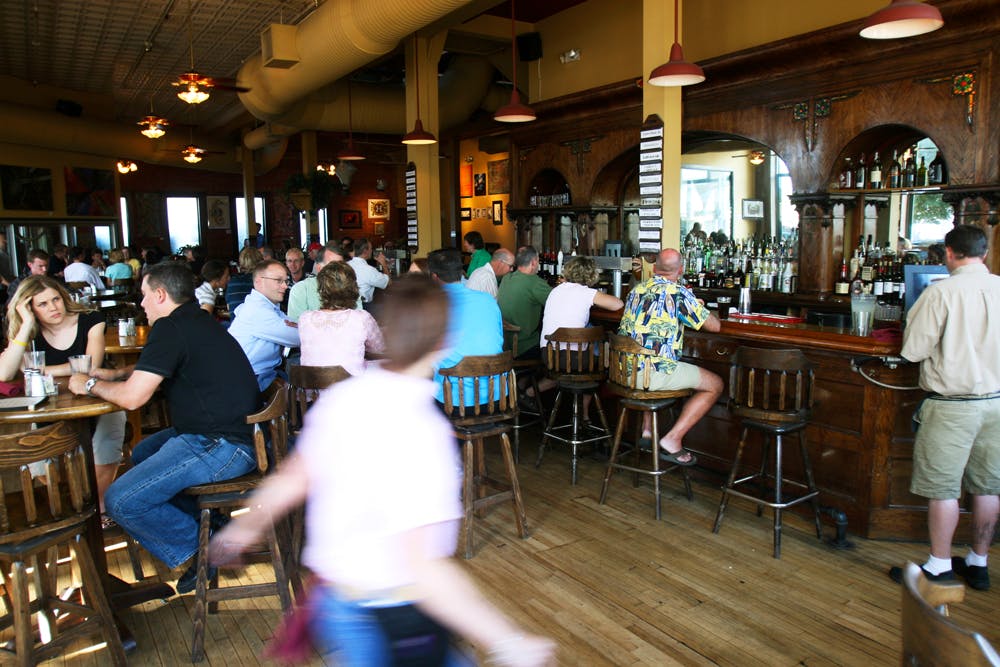 People sit at tables and a bar at Phantom Canyon Brewing Company in Colorado Springs