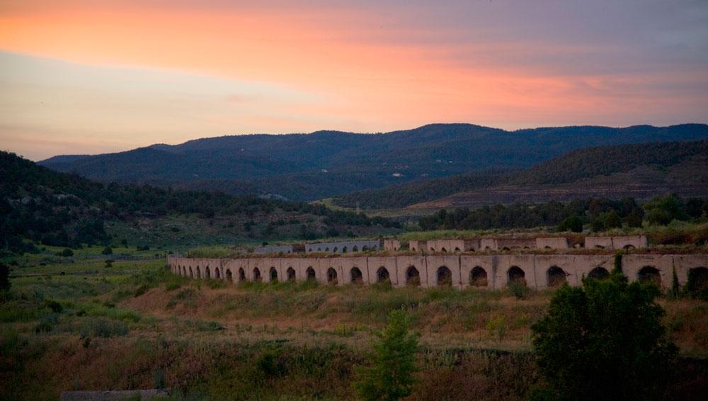 A row of abandoned brike ovens that resemble Roman ruins