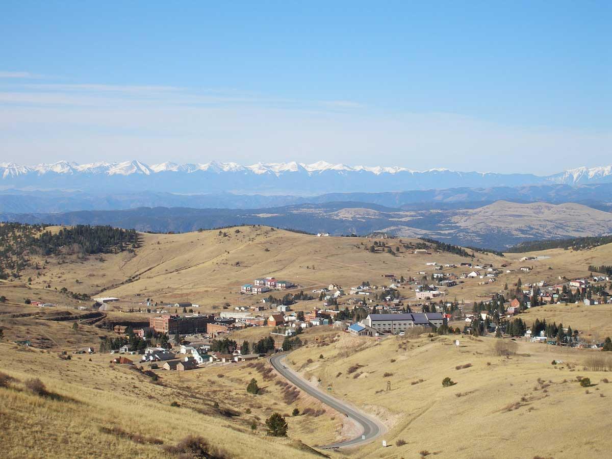 Viewed from part of the Gold Belt Tour scenic byway, Cripple Creek is a small town spread out over the rolling hills of Colorado. In the distance, snow-capped mountains create a formidable natural wall.