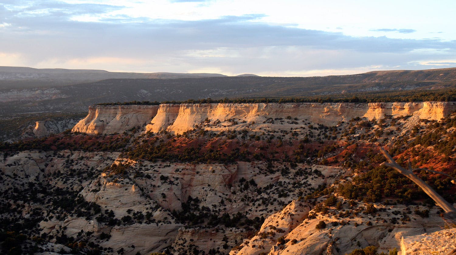 The sun's fading light colors the rock faces of Dinosaur National Monument orange.