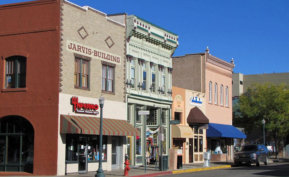 Pink, green and gray storefronts dating back to the 1800s line a street in downtown Durango, Colorado.