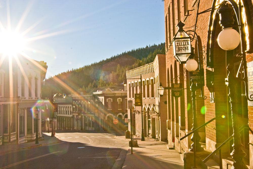 The sun shines brightly on the streets of Central City. Beautiful red-brick buildings and Victorian homes line the block.