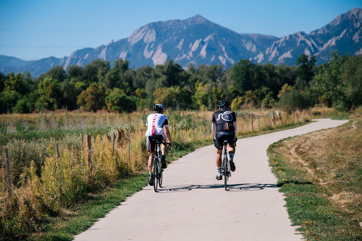 Cyclists head west toward the Flatirons