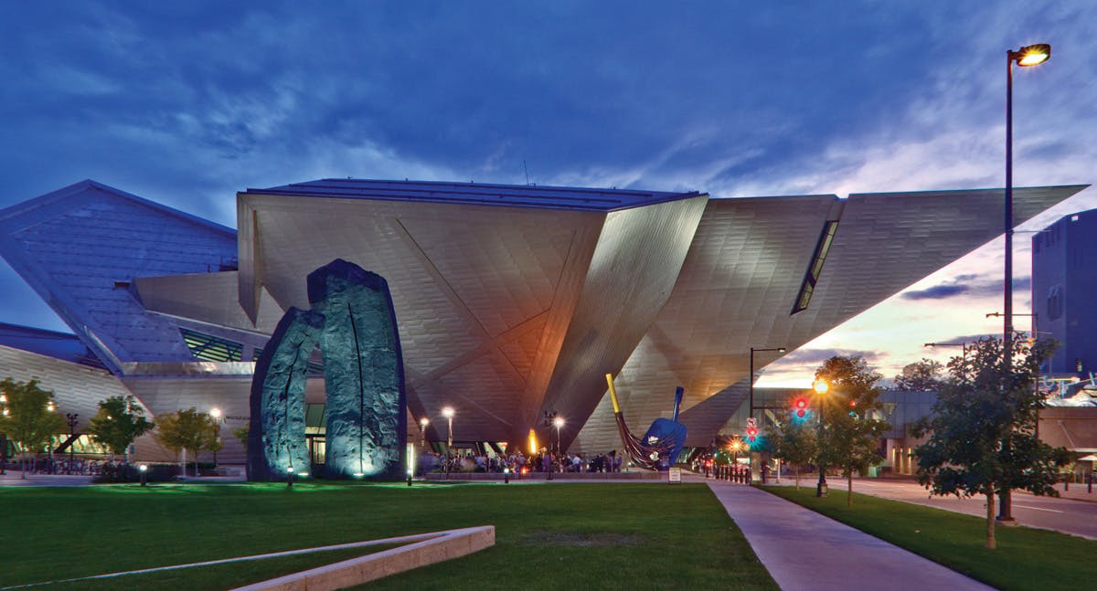 The architecturally-innovative, inverted-styled Frederic C. Hamilton Building is lit up at night at the Denver Art Museum.