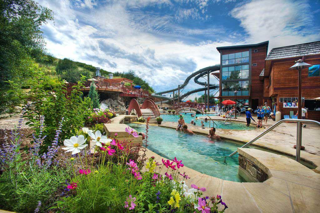 People soaking in Old Town Hot Springs in Steamboat Springs on a sunny day