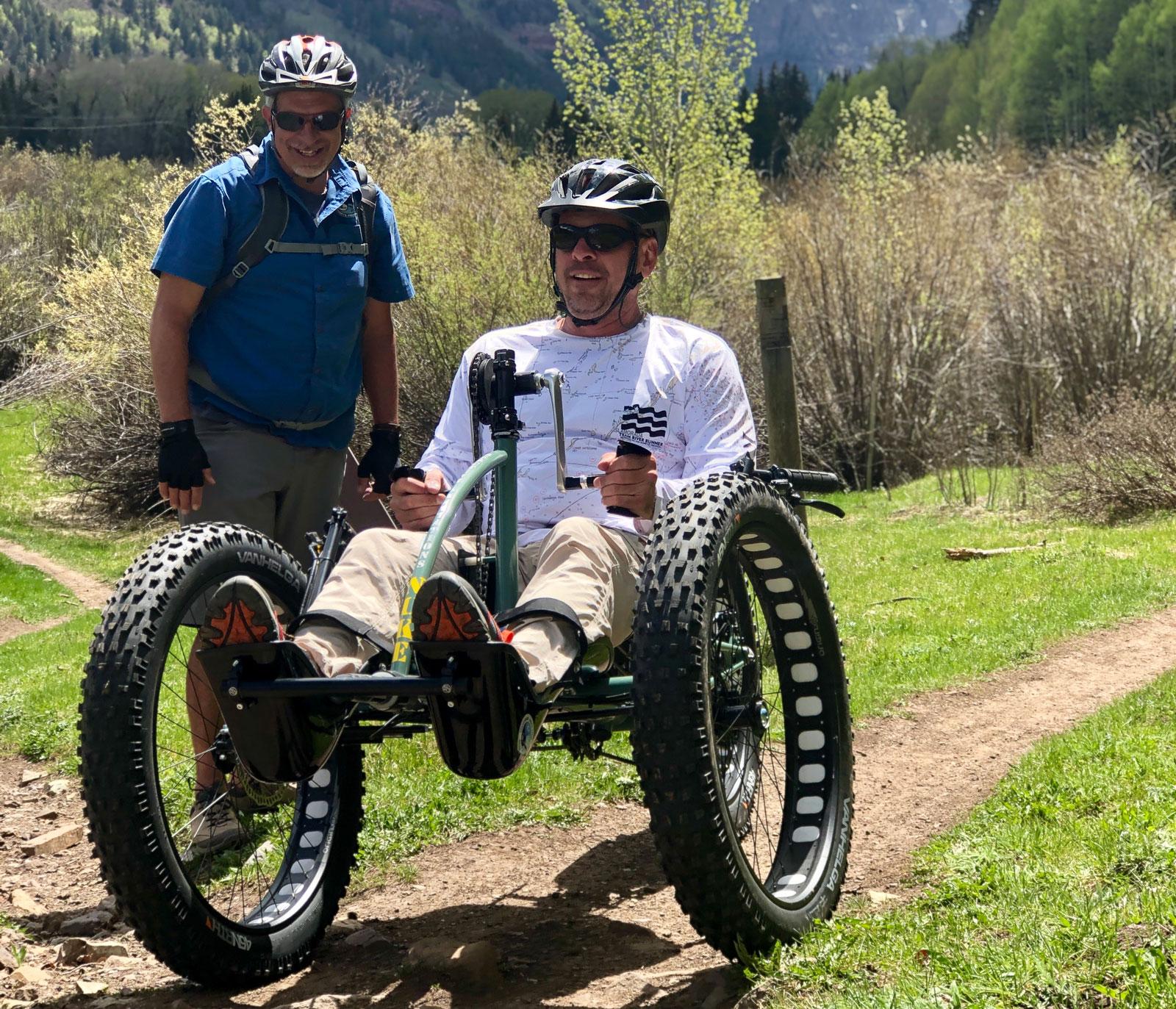 A cyclist uses an adaptive bike with thick tires and a hand peddle near Telluride, Colorado.