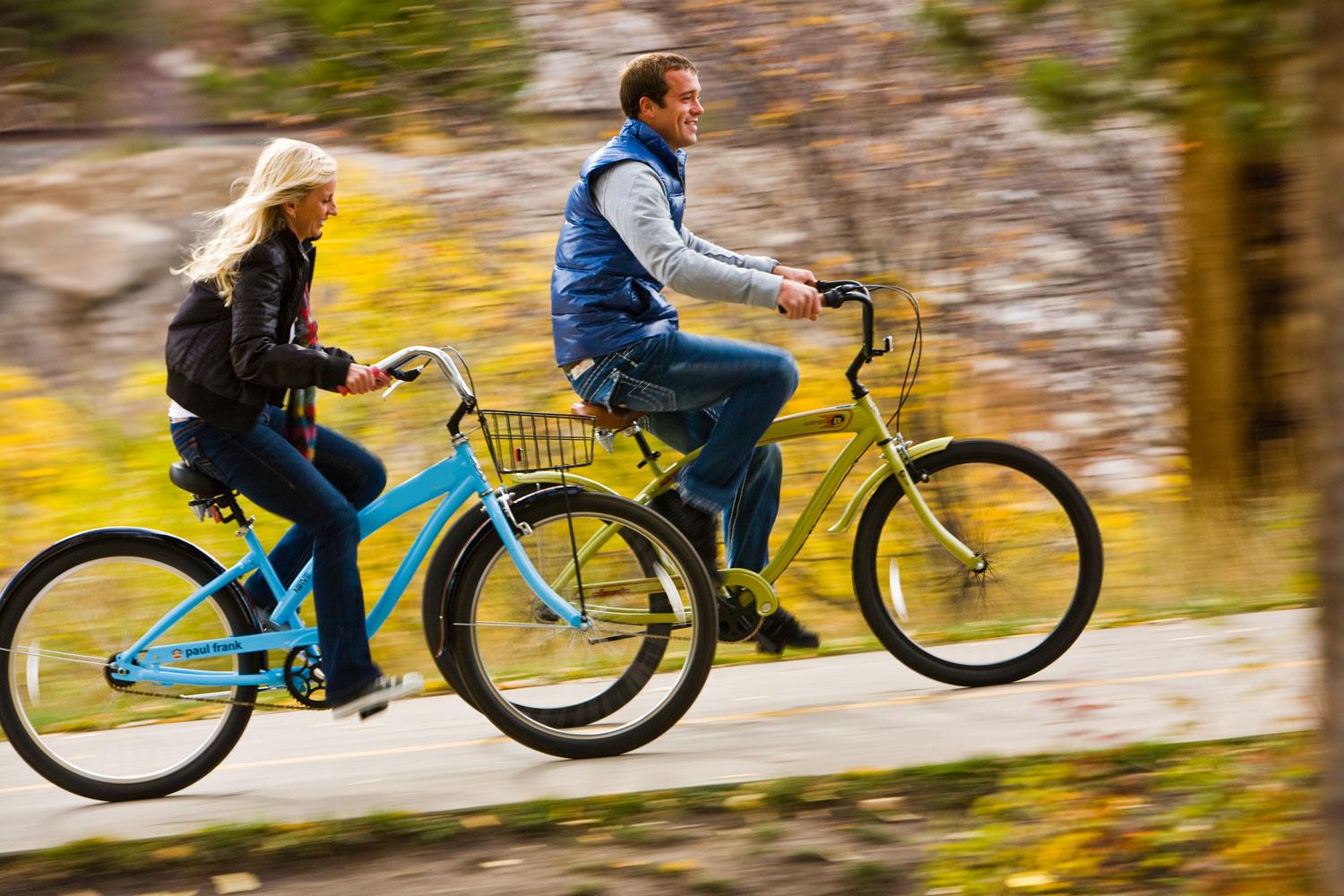 A couple bikes past colorful countryside on a scenic road