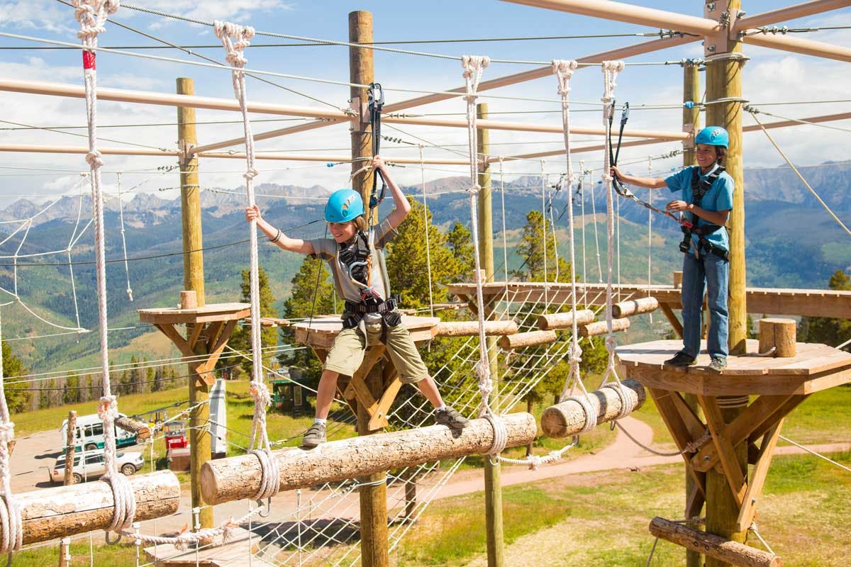 Kids cross a ropes course at Epic Discovery in Vail