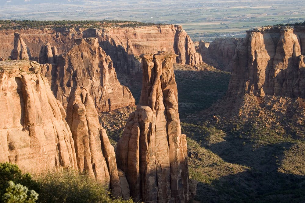 Several dramatic red-rock formations erupt from the ground to create a canyon inside the Colorado National Monument.