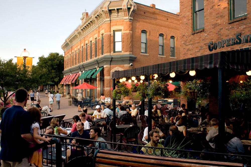 People enjoy the warm weather by dining on an outside terrace in Old Town in Fort Collins.