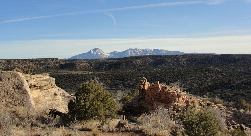 Ute Mountain, said to resemble a sleeping Ute Chief, can be seen in the distance under a blue sky