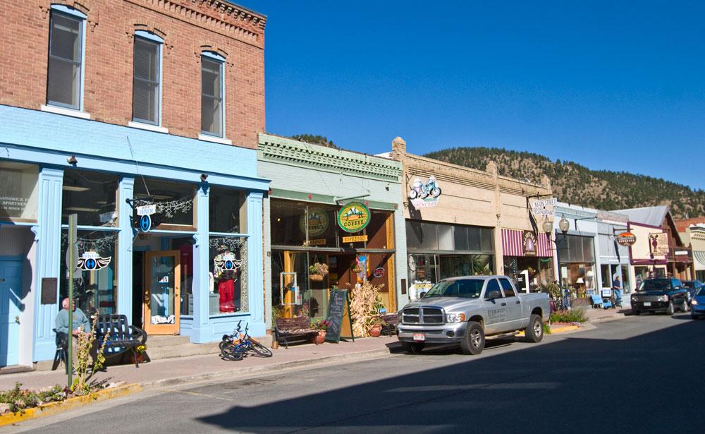 Victorian-era brick storefronts, pained in blues, yellows and greens line Idaho Springs' main street