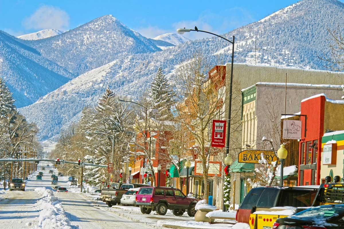 A snow-covered street in downtown Buena Vista during a bluebird day with snow-capped mountains in the background. 