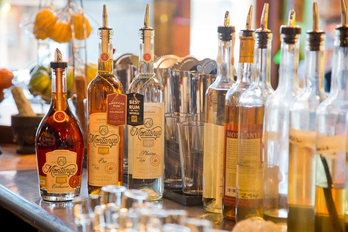 Bottles of spirits line the counter at Montanya Distillers in Crested Butte