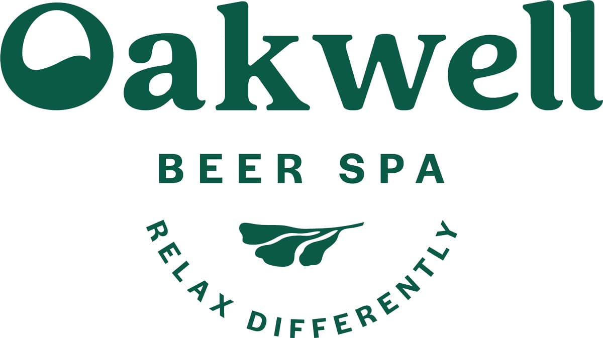 The logo for Oakwell Beer Spa in Denver that says "Oakwell Beer Spa: Relax Differently." in dark green letters.