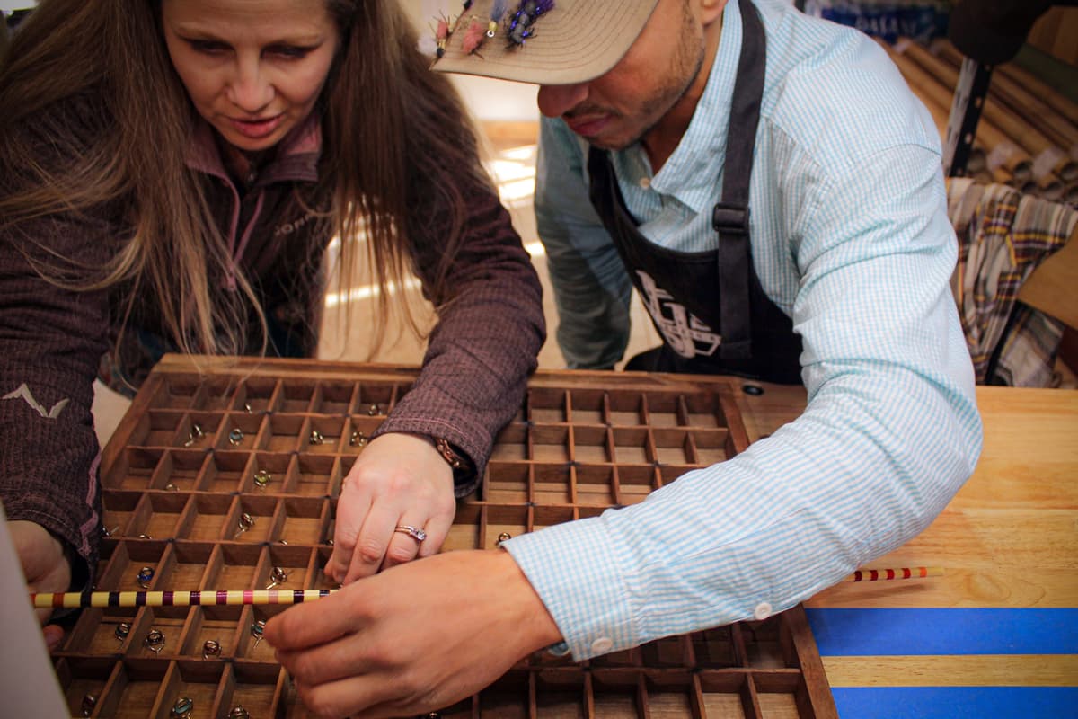 Two people, one instructor and one student, pick out a perfect stripping guide for their handmade fly-fishing rod at PJ's Fine Bamboo Rods in Pagosa Springs.
