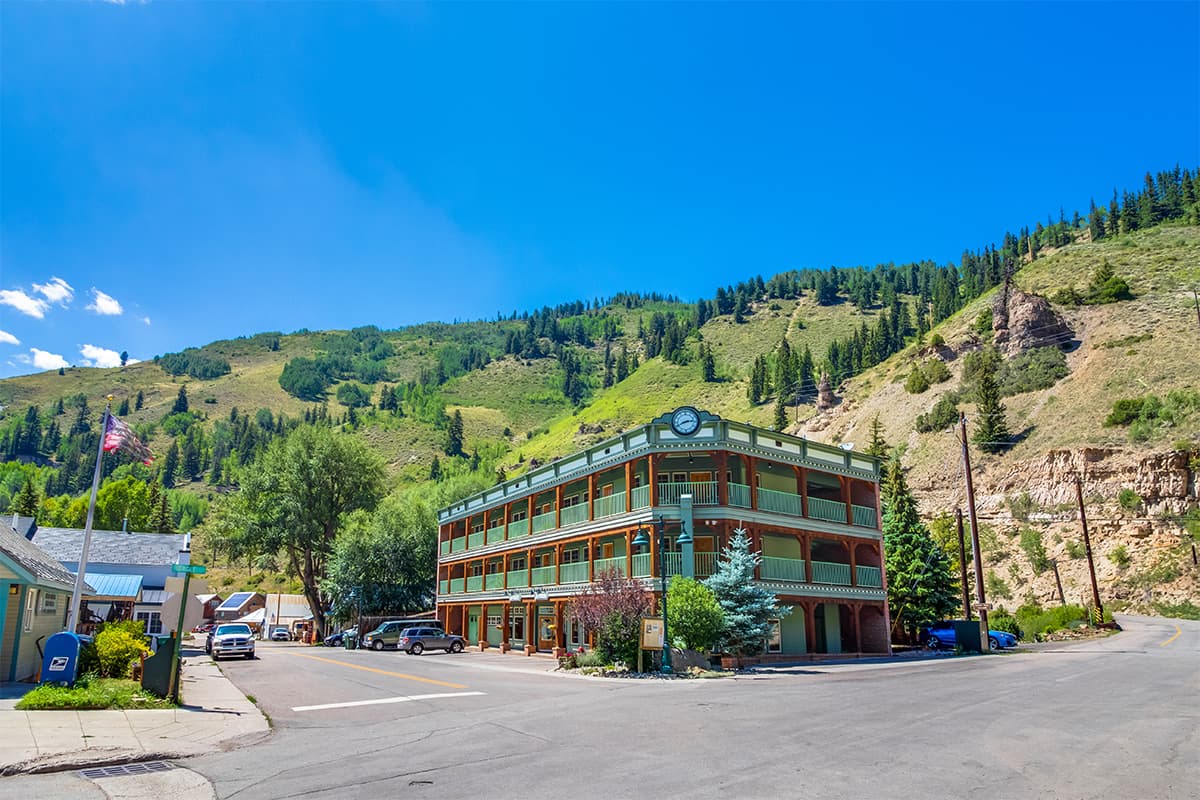 The Green Bridge Inn is a charming lodging in Red Cliff, Colorado. The inn stands out with its wooden beams and green wraparound balconies.