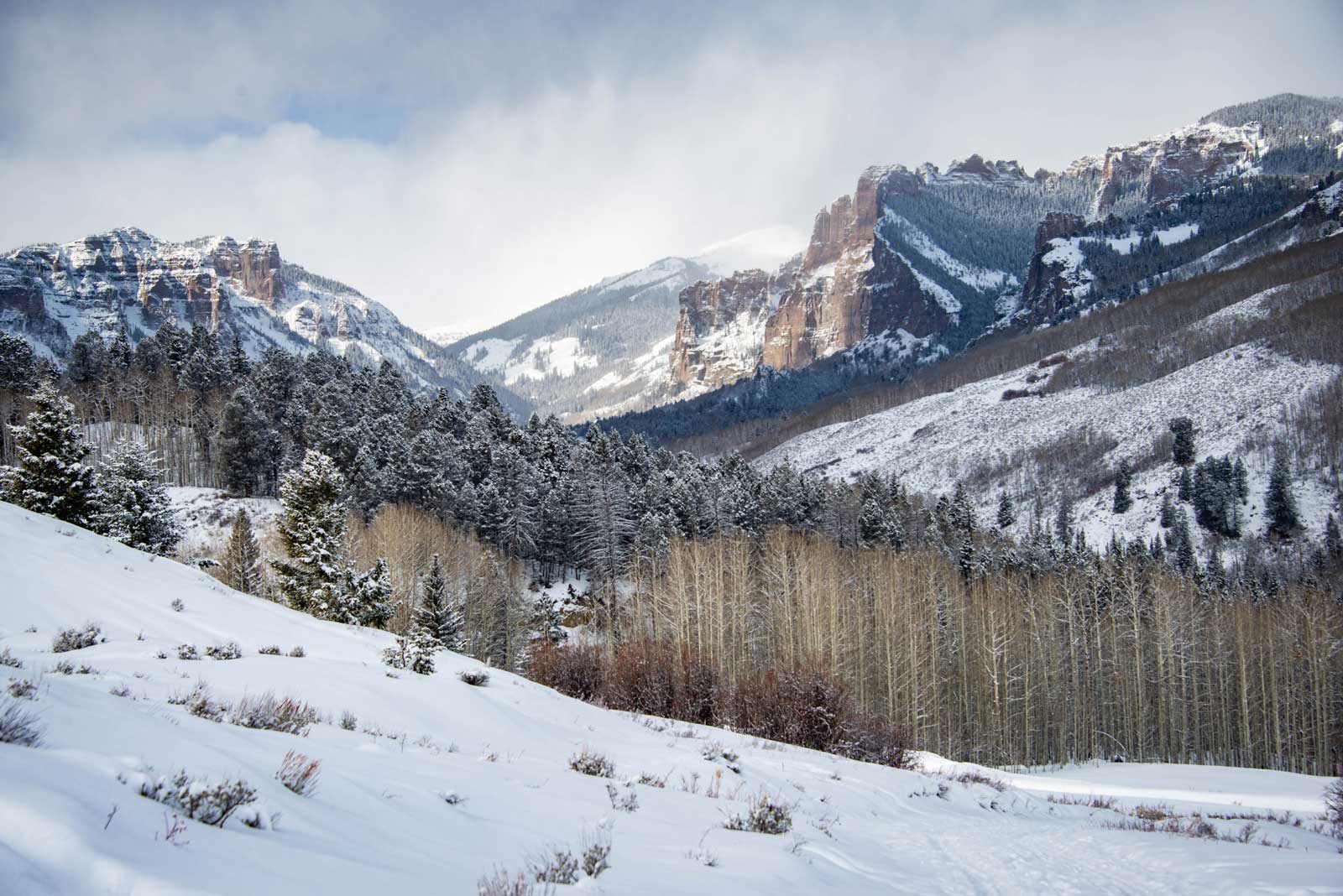 A dusting of snow covers sheer cliffs and peaks in Gunnison