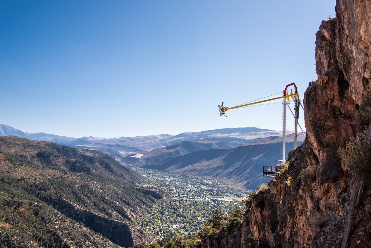 Soaring over the Colorado River on the Giant Canyon Swing, which is perched on the edge of a cliff in Glenwood Springs, Colorado.