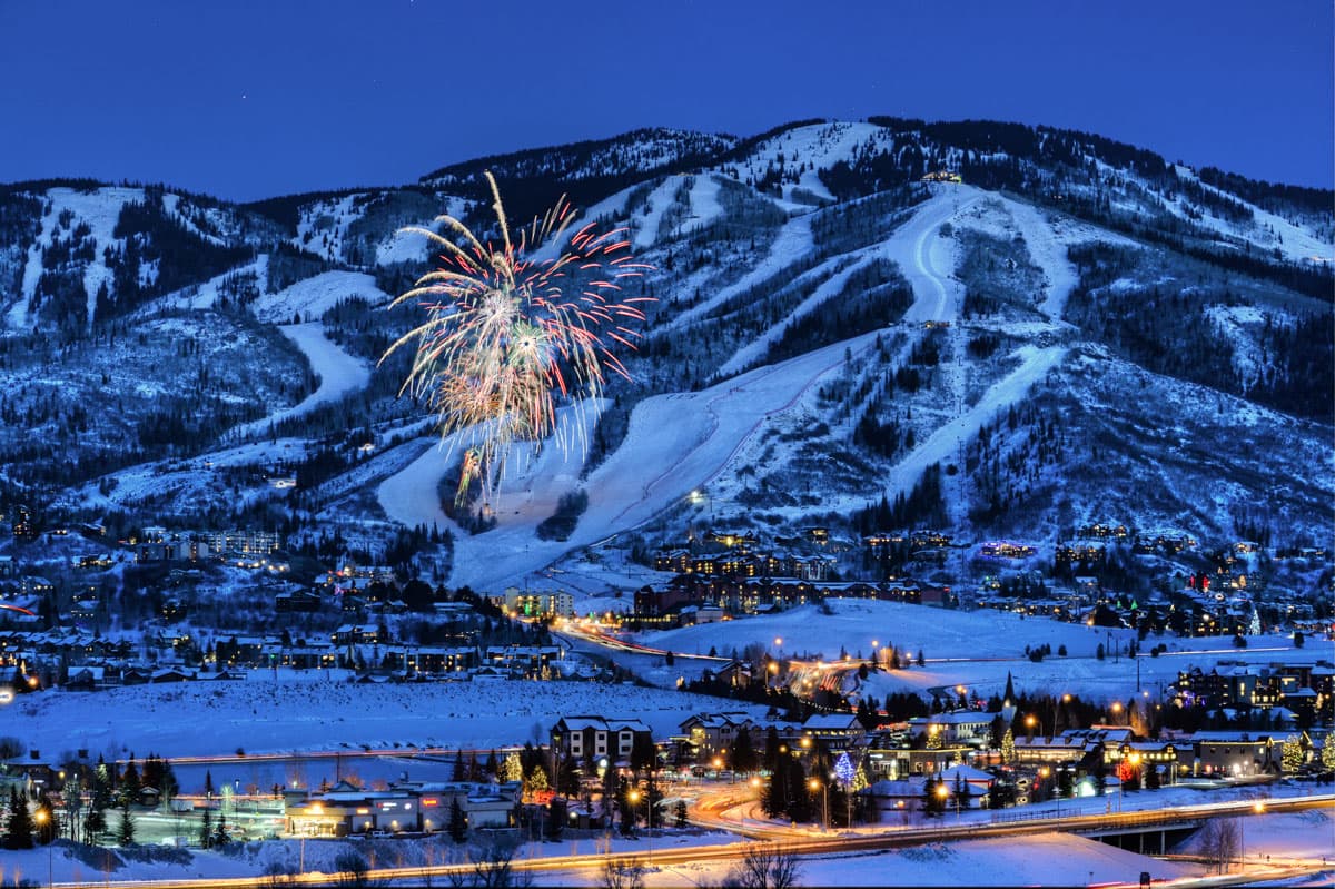 New Year's Eve fireworks over Steamboat Ski Resort in Colorado with a stunning winter mountain backdrop.
