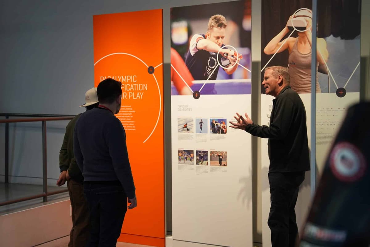 A tour guide talks to people about an exhibit on paralympians at the U.S. Olympic & Paralympic Museum in Colorado Springs