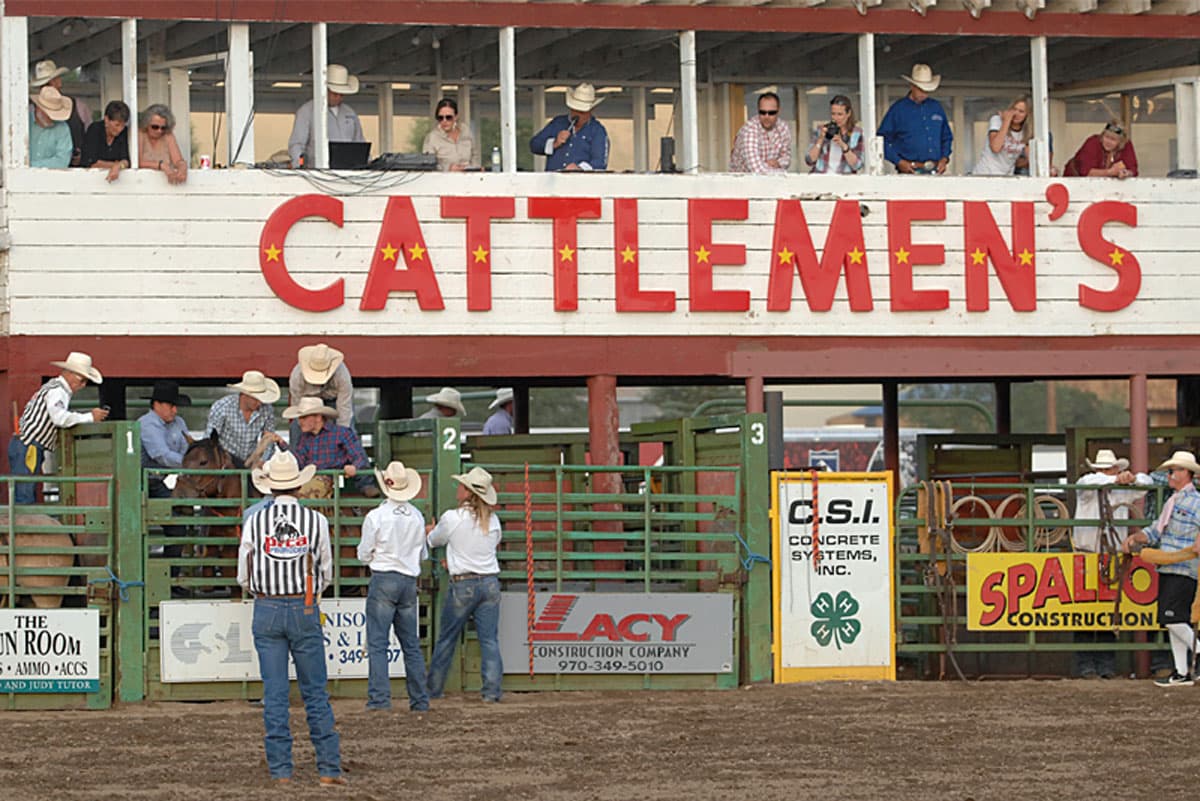 Riders in cowboy hats preparing to compete at Cattlemen’s Days Rodeo.