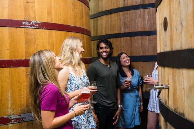 Group viewing large wooden casks at New Belgium Brewery in Fort Collins