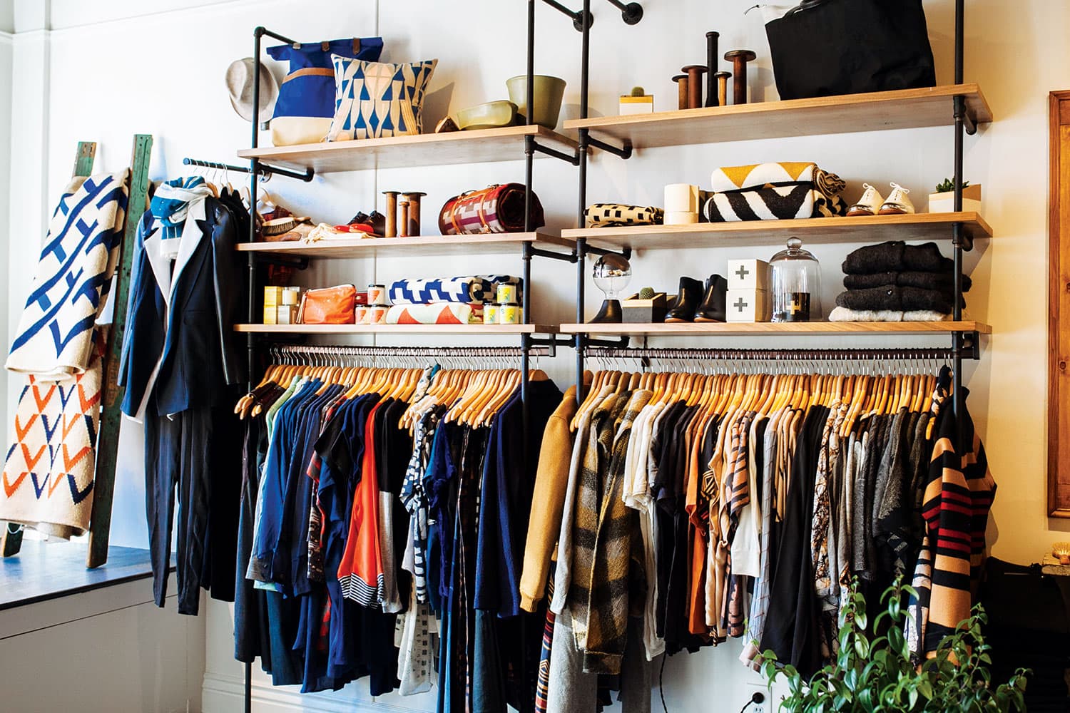 Clothes hang on a rack at Cedar & Hyde Boutique in Boulder