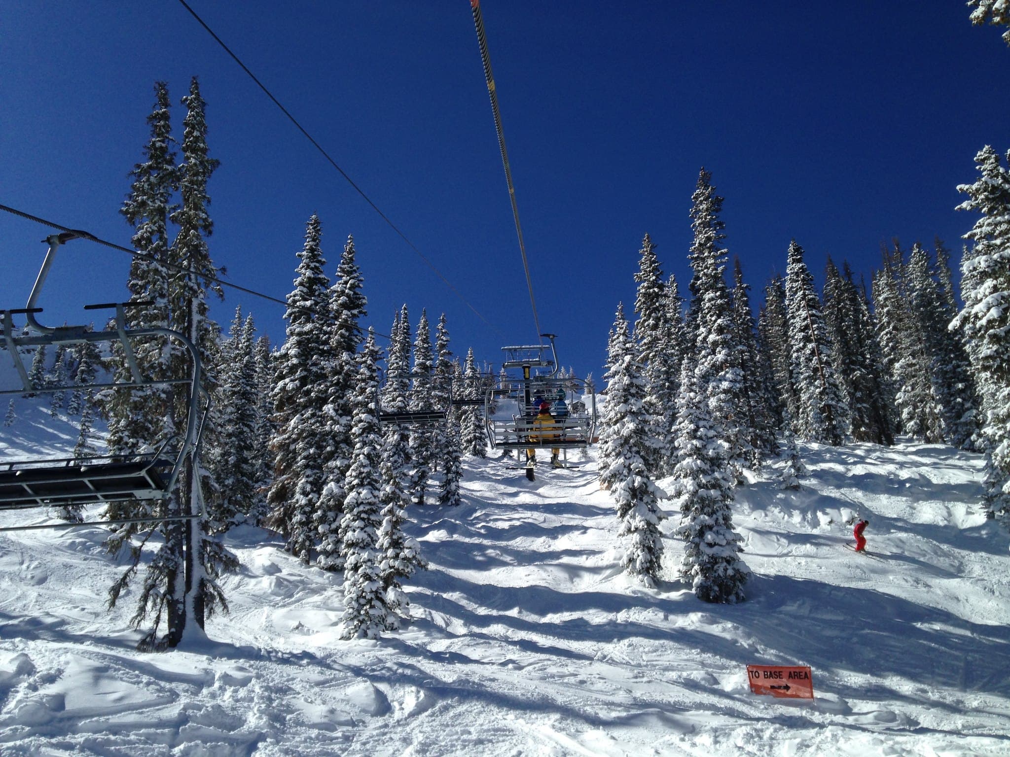 A group is whisked over a snowy field on a ski lift in Pagosa Springs
