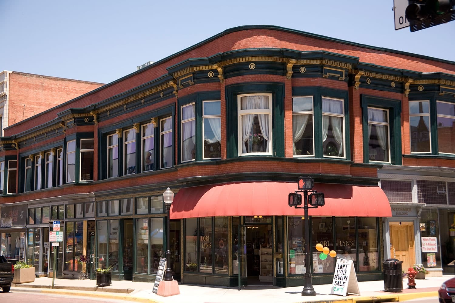 A brick building on a corner in El Corazón de Trinidad, the Trinidad Creative District on a sunny day